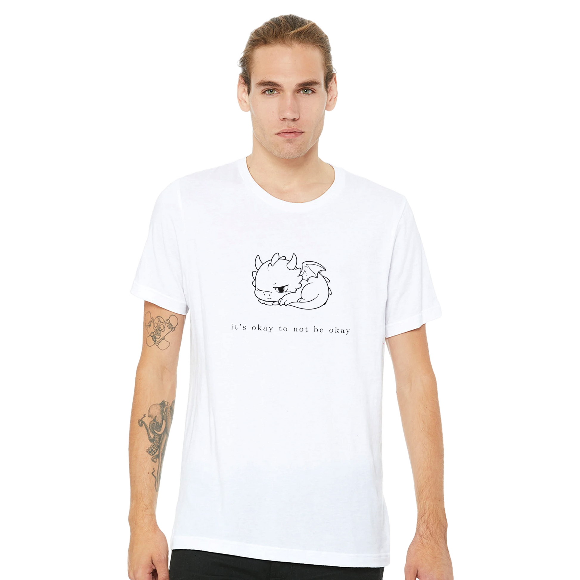 Man wearing white It's Okay To Not Be Okay tee with minimalist Grix dragon line art