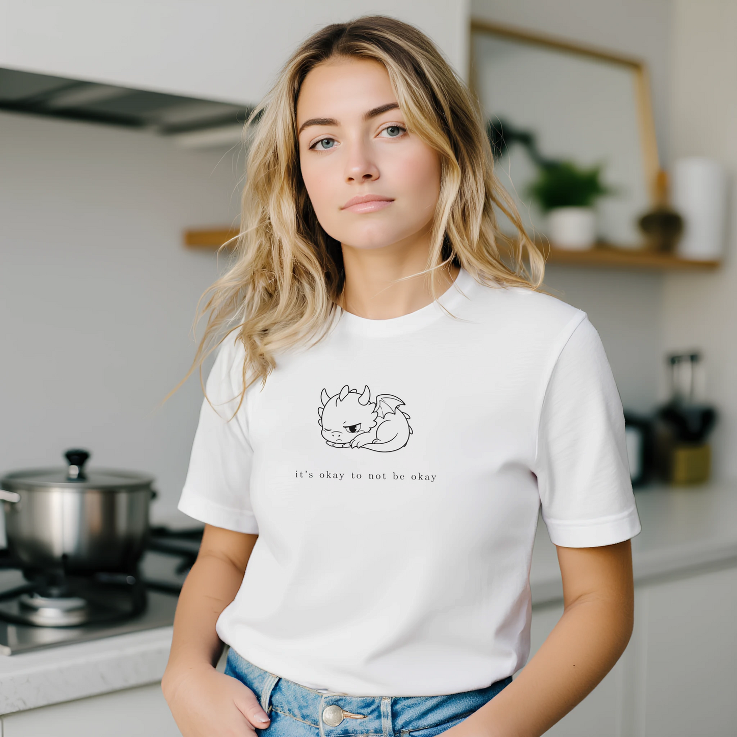 Woman in cozy white dragon t-shirt with It's Okay To Not Be Okay design